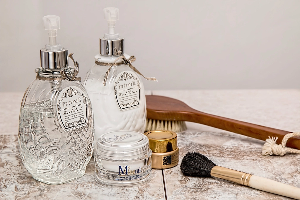 Labeled skincare bottles and brushes on a marble counter - learning to read a skincare label